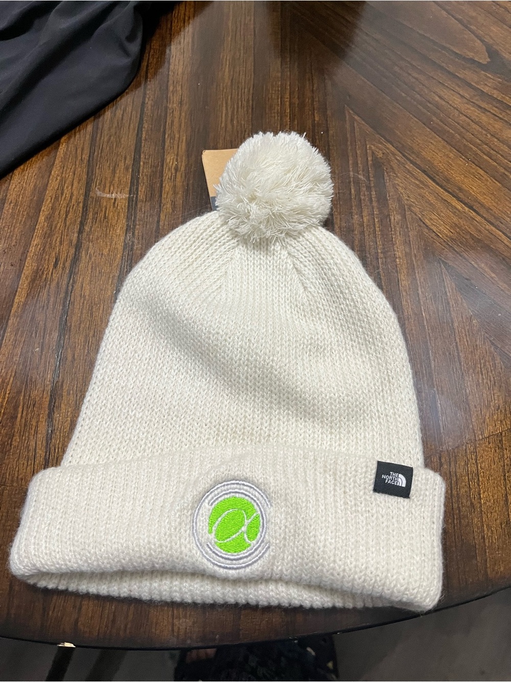 The North Face women Cream Pom Beanie with Green Tennis Patch